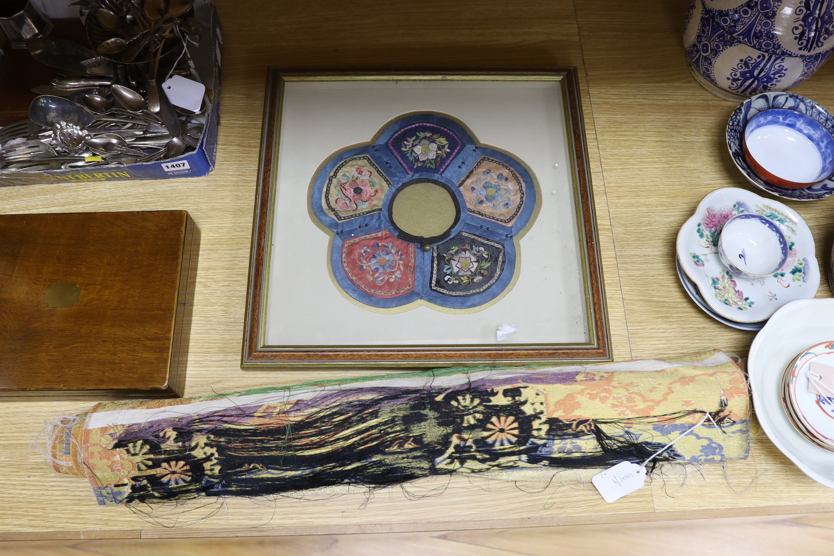 A roll of Japanese brocade fabric, (possibly for an Obi) and a framed Chinese silk embroidered child’s collar, collar 27cm diameter